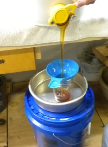 Transferring honey to jars.